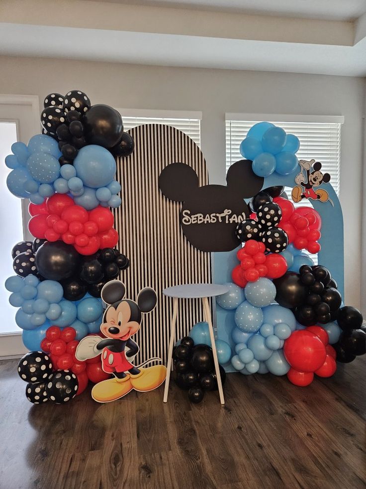 a mickey mouse balloon arch with balloons