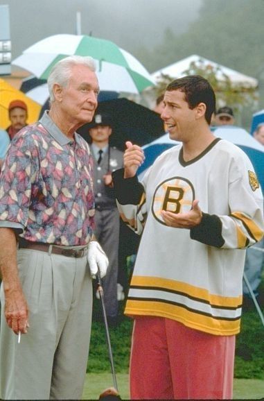 two men standing next to each other near umbrellas