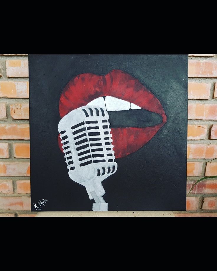 a painting of a woman's lips with a microphone in front of it on a brick wall