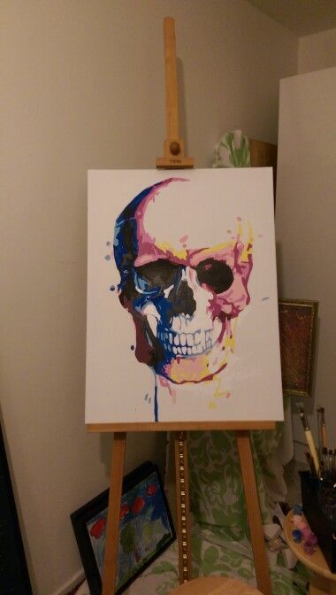 an easel with a skull painted on it