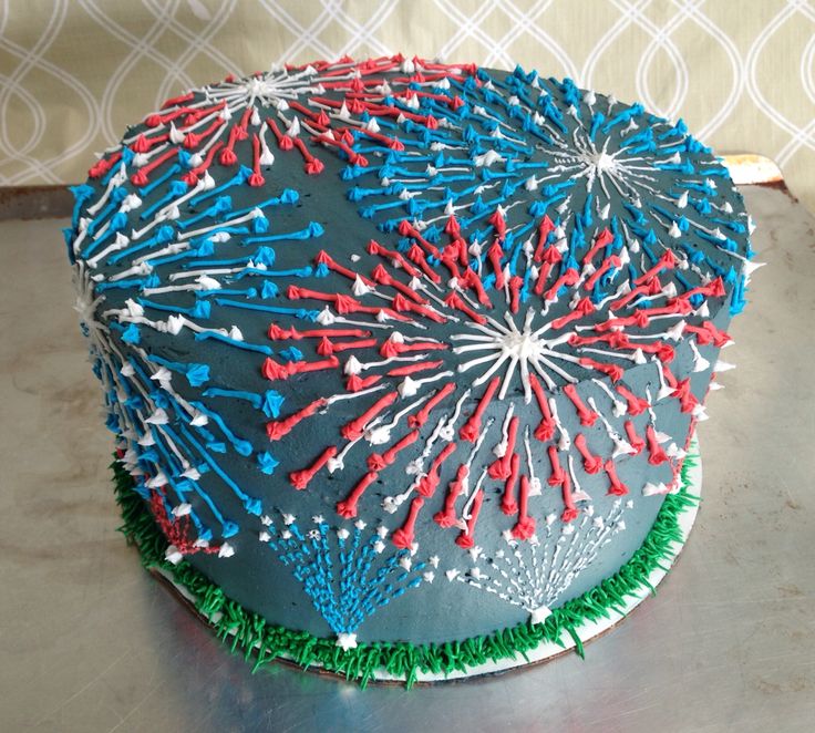 a cake decorated with red, white and blue sprinkles on top of a table