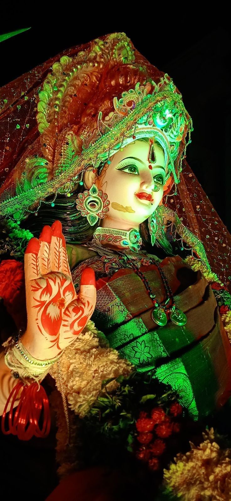 a close up of a person wearing a costume and holding their hand in front of her face