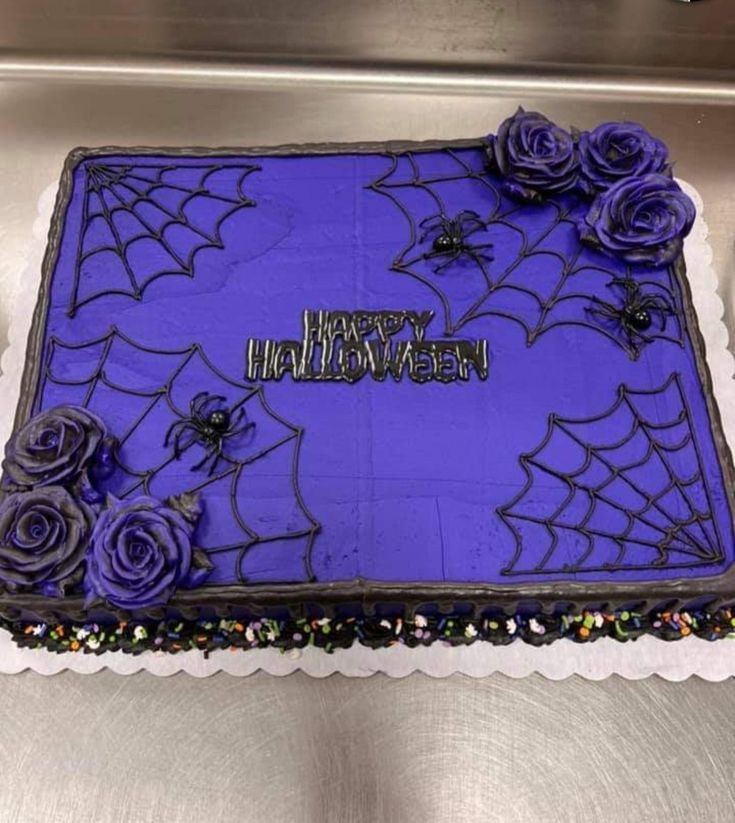 a birthday cake decorated with purple frosting and flowers