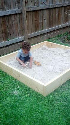 a little boy playing in the sandbox