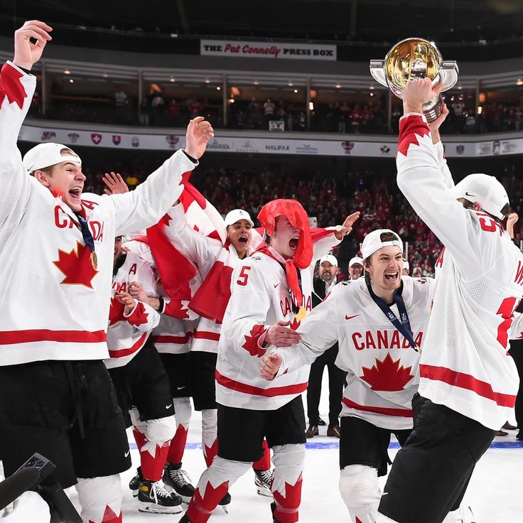 the hockey team is holding up their trophy and celebrating with other players on the ice