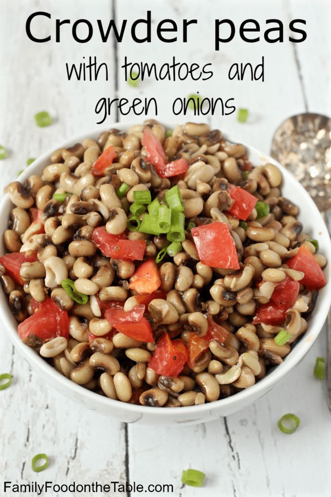 a white bowl filled with black eyed peas and tomatoes