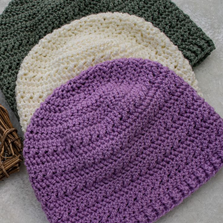 three crocheted hats laying next to each other