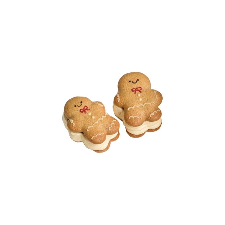 two small cookies with bows on them sitting next to each other in front of a white background