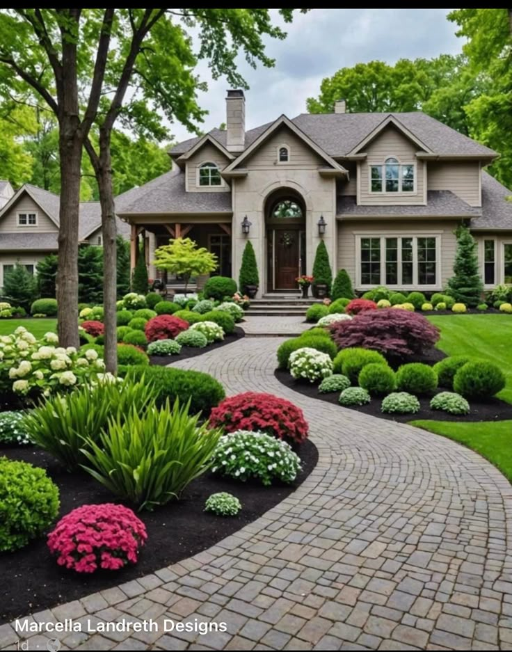 a large house with landscaping around the front yard and walkway leading up to it's entrance