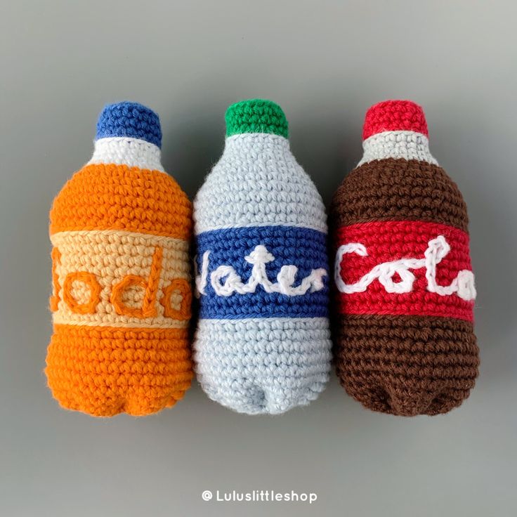 three crocheted soda bottles sitting next to each other