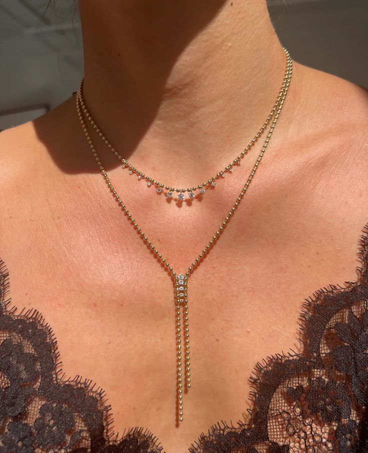 A little bit sexy and totally cool, the Gemini Bolo is a new take on the classic style. Our signature ball chain is designed with a dueling silhouette that delicately holds a graduating row of diamonds that feels like they're almost floating. The epitome of versatility, the Gemini Bolo is the necklace that can be easily dressed up or down. 14k Yellow Gold Diamond: 0.27 total carat weight Stones: natural white diamonds Length: 19 inch chain with a 3 inch drop Puffy Heart Necklace, Floating Necklace, Puffy Heart, Evil Eye Necklace, Handmade Gold, Butterfly Necklace, Baguette Diamond, Eye Necklace, Ball Chain