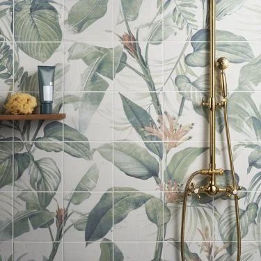 a bathroom with a shower head, shelf and wallpaper that has green leaves on it