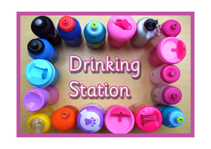 the words drinking station surrounded by many different colored cups