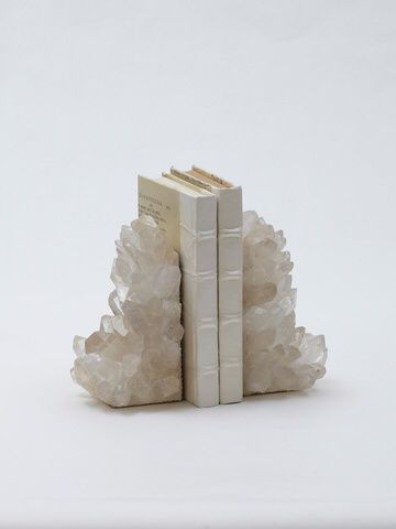 two books are stacked on top of each other in front of a white background,