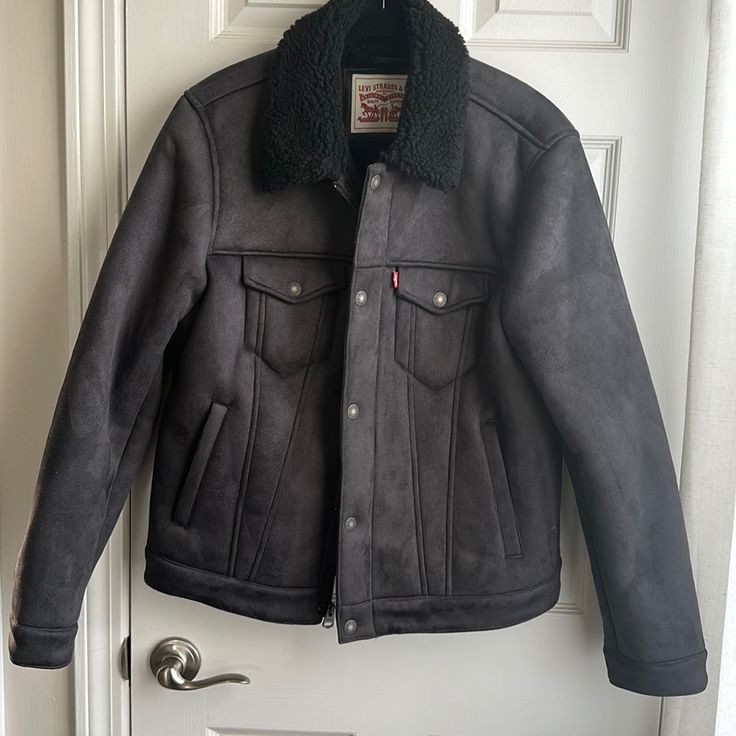 Nwot Faux Suede Sherpa Jacket From Levi’s. Faux Suede Exterior With Teddy Sherpa On The Collar And Interior. Denim Jacket Styling With A Full Front Zipper With Snap Closure. 2 Side Pockets With Snap Closure Chest Pockets. Perfect Fall Jacket. Pit To Pit: 23in Point To Point: 19in Shoulder To Hem: 24.25 In Center Back To Hem: 25in Gray Outerwear With Faux Fur Lining For Cold Weather, Levi's Winter Outerwear With Fleece Lining, Levi's Fleece-lined Winter Outerwear, Levi's Fitted Outerwear For Cold Weather, Black Sherpa Fleece Jacket With Pockets, Levi's Black Winter Outerwear, Black Sherpa Casual Outerwear, Casual Black Sherpa Outerwear, Denim Jacket Fashion