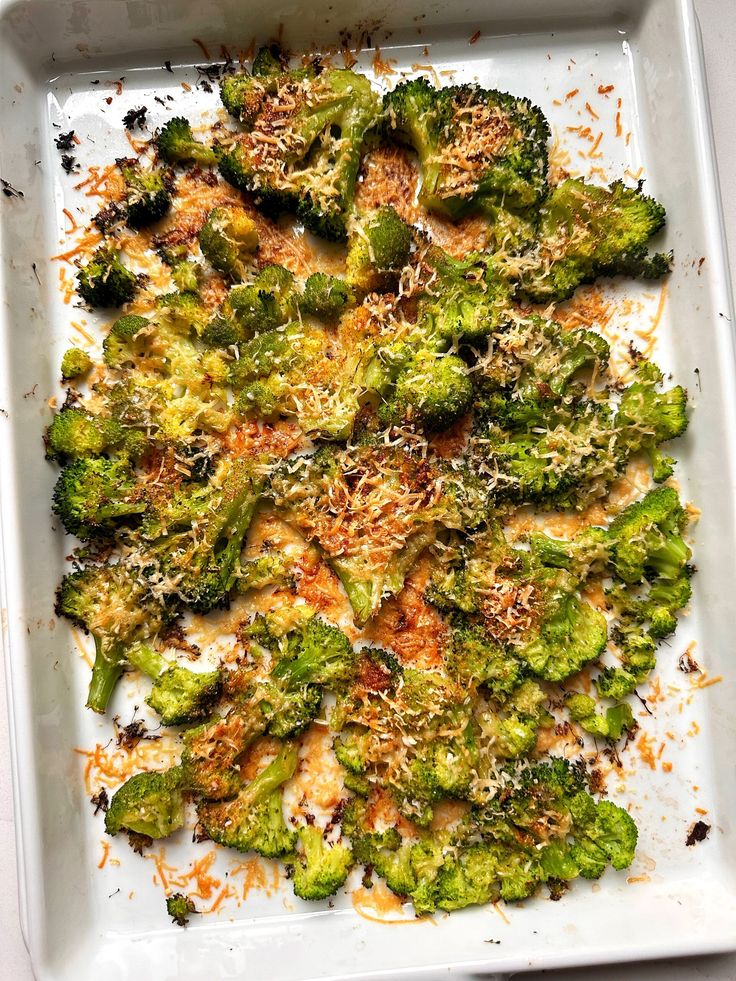 broccoli florets with parmesan sprinkles on a white plate