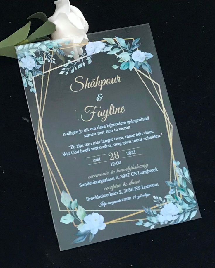 a wedding card with a white rose on top and blue flowers in the bottom corner