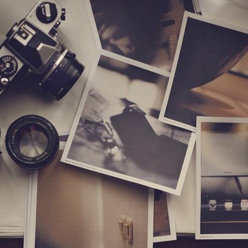 several polaroid photos and a camera sitting on top of a table