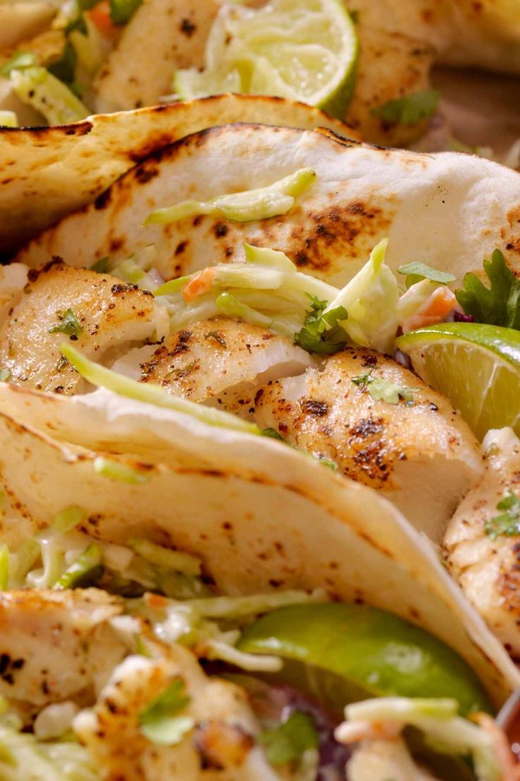 chicken, lettuce and lime tacos on a plate