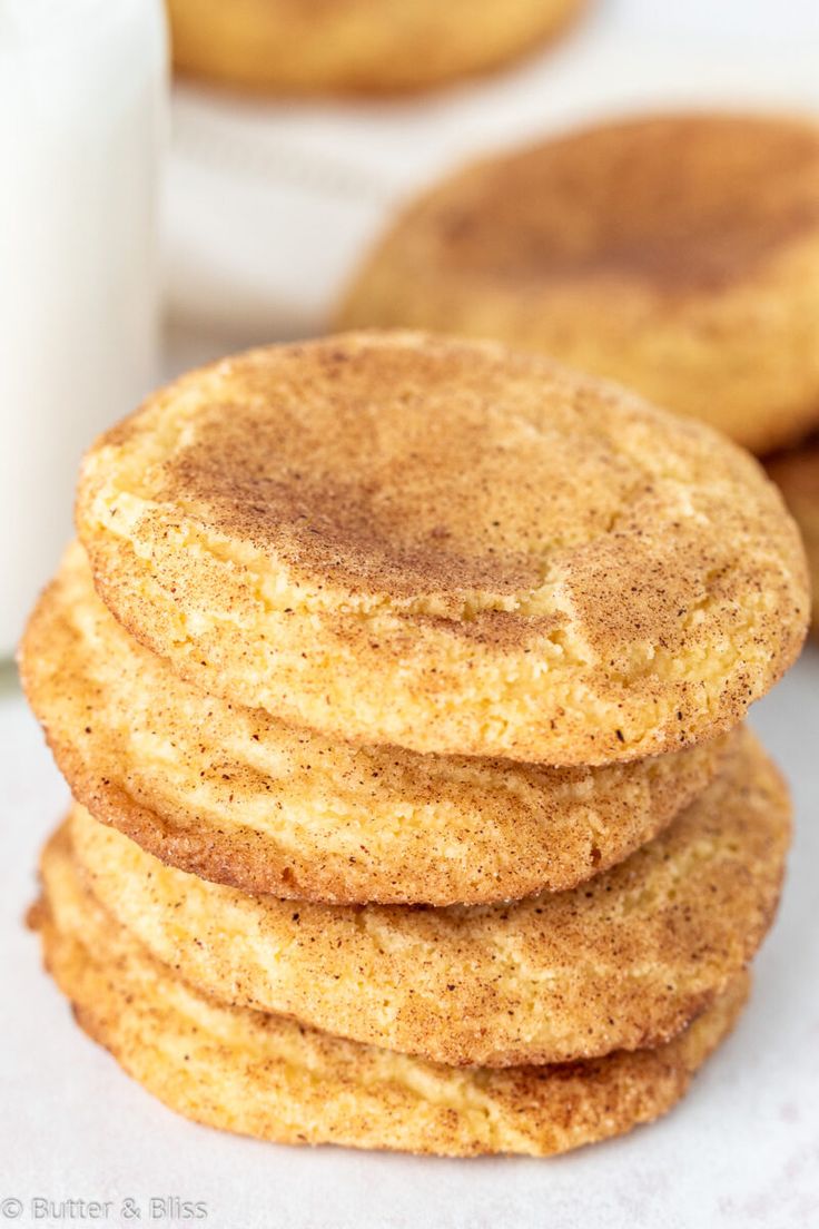 a stack of cookies next to a glass of milk