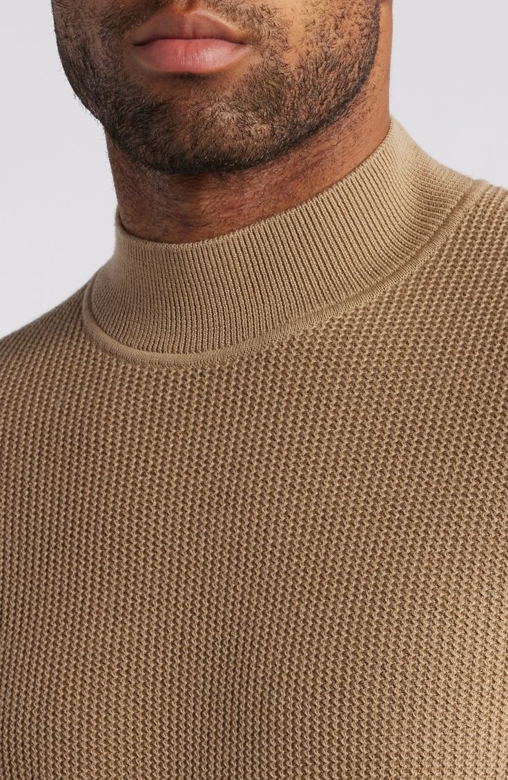 Feel the polish of this staple sweater designed with a high neckline and slightly dropped shoulders. Mock neck Long sleeves 50% lyocell, 50% cotton Machine wash, dry flat Made in Turkey High Neck Merino Wool Tops For Layering, Spring Merino Wool Top With Ribbed Collar, Beige Turtleneck Top With Ribbed Collar, Beige Turtleneck Sweater With Ribbed Neckline, Merino Wool Turtleneck Top For Spring, Spring Merino Wool Turtleneck Top, Casual Beige Merino Wool Tops, Classic Knit Funnel Neck Top, Beige Cotton Turtleneck Top