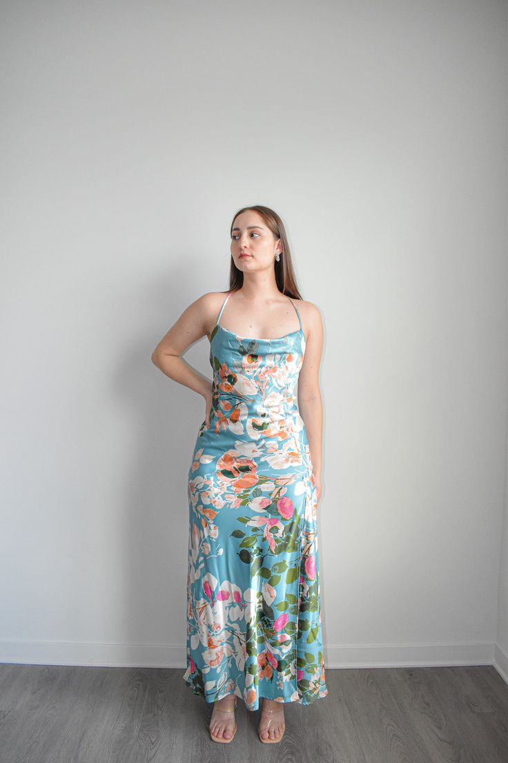 Expertly crafted with a floral print, this satin slip dress features an elegant open back design. The refreshing mint color adds a touch of allure to any occasion. Perfect for those looking for a stylish and sophisticated look. The satin material drapes gracefully, ensuring a flattering silhouette that flows with every step. Elevate your wardrobe with this statement piece that seamlessly combines the allure of florals with the timeless appeal of a satin slip dress. Step into the spotlight with c Spring Feminine Satin Dress With Spaghetti Straps, Feminine Spring Satin Dress With Spaghetti Straps, Green Satin Slip Dress For Brunch, Feminine Satin Dress With Spaghetti Straps For Spring, Satin Maxi Dress With Floral Print For Garden Party, Green Satin Slip Dress For Spring, Floral Print Satin Midi Dress For Summer, Spring Silk Backless Maxi Dress, Floral Print Satin Midi Dress For Garden Party