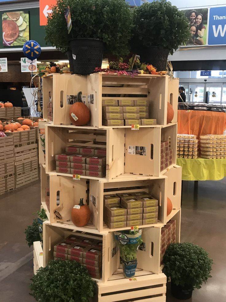 a display in a store filled with lots of boxes and crates full of vegetables on top of each shelf