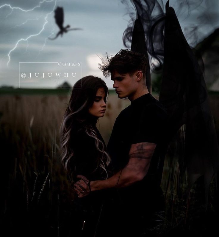 a man and woman standing next to each other in front of a field with lightning