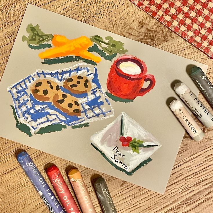 some crayons are sitting on a table next to an art project with cookies