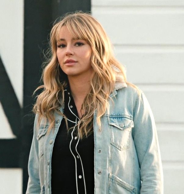 a woman in black shirt and jean jacket