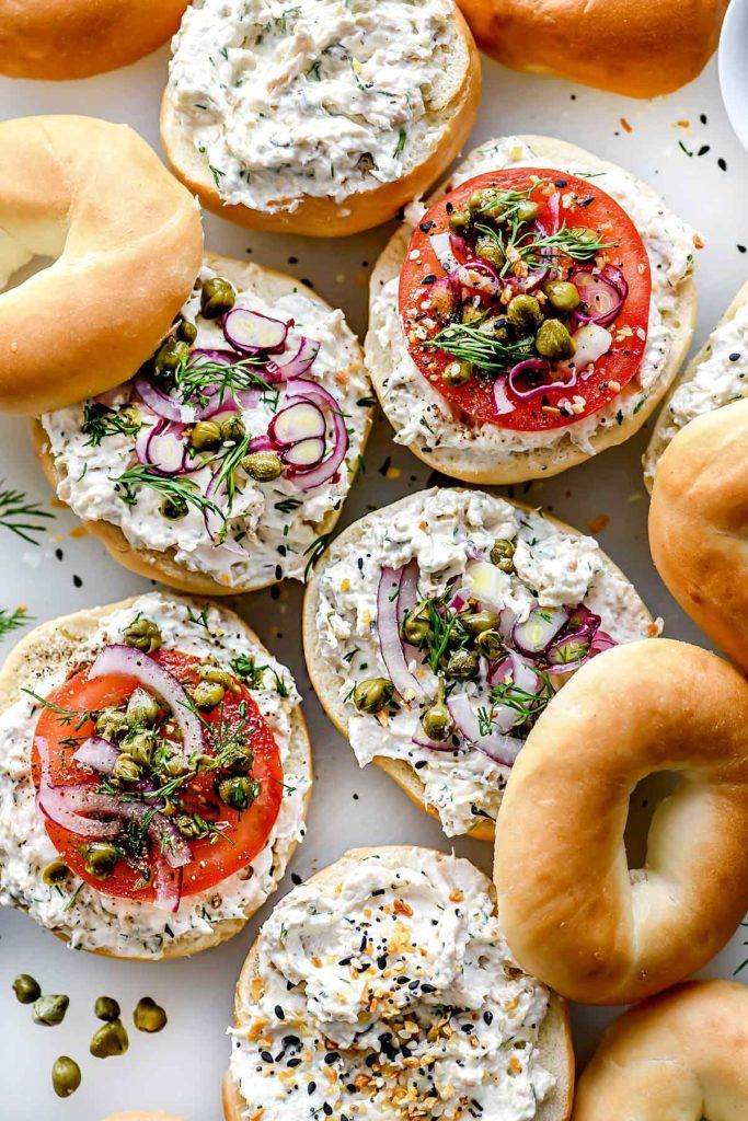 an assortment of bagels with different toppings on them