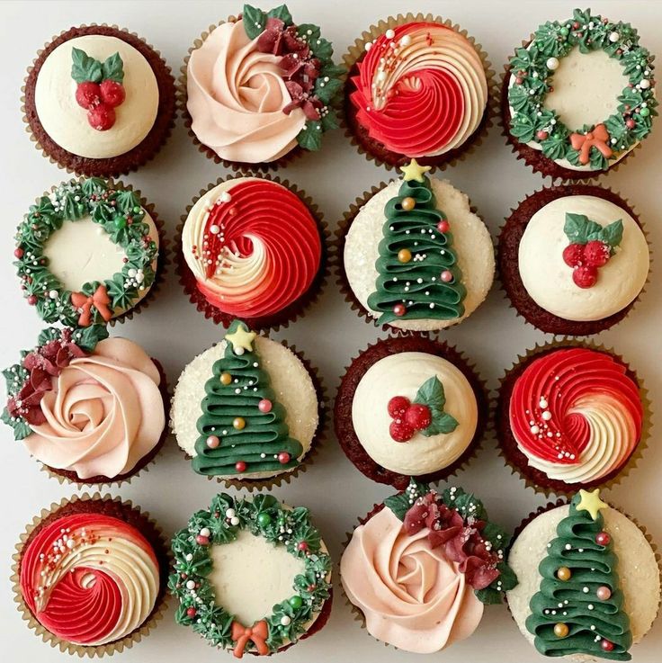 twelve decorated cupcakes arranged in rows on a white surface with christmas trees and decorations