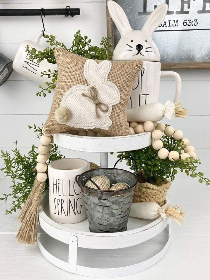 a white shelf topped with baskets filled with plants and stuffed animals on top of it