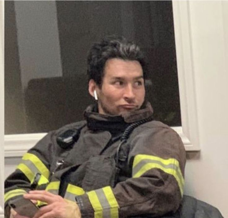 a man in a fireman's uniform sitting down