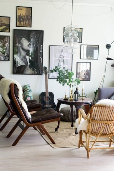 a living room filled with furniture and pictures on the wall