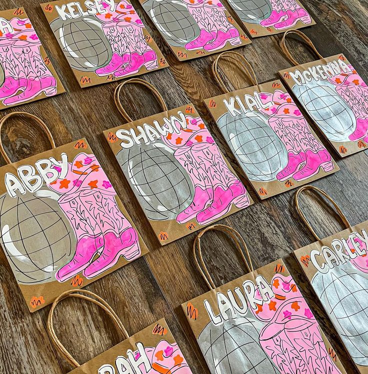 several bags with different designs on them sitting on a wooden table next to each other