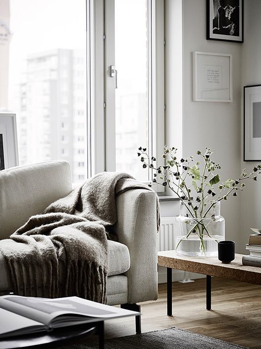 a living room with a couch, coffee table and pictures on the wall above it