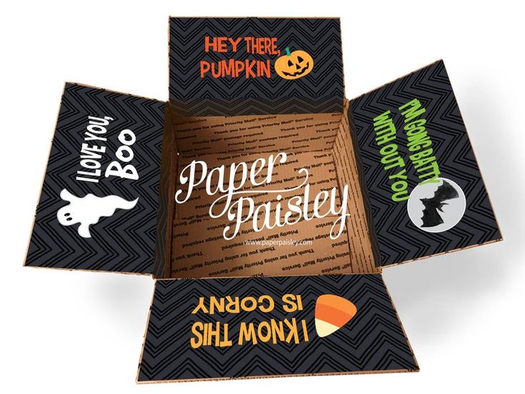 an open box with halloween stickers on the front and back sides, inside it