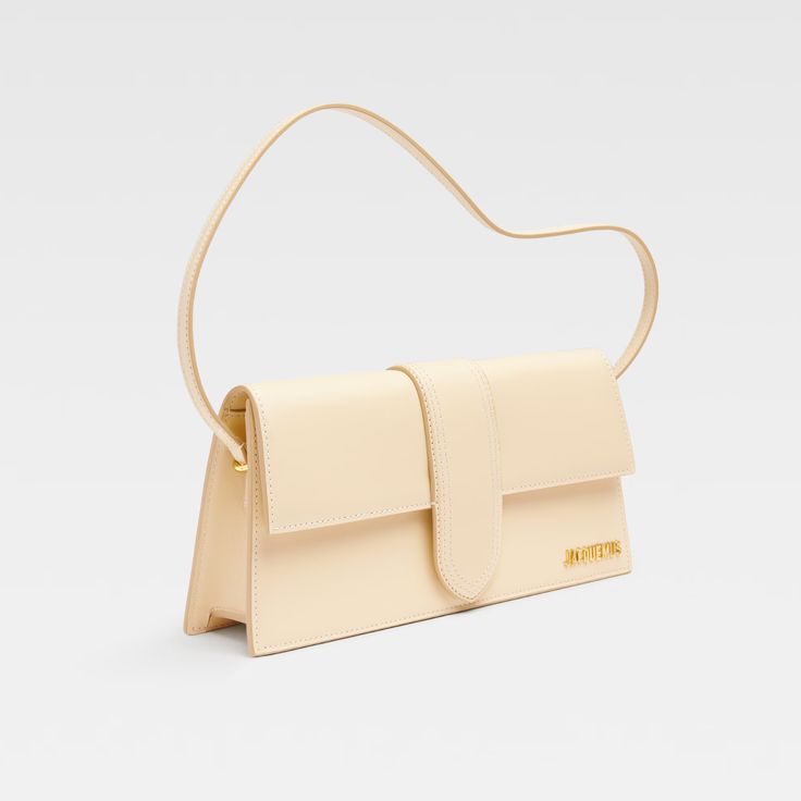 The long Bambino in ivory is the perfect accessory for anyone looking to make a statement. Crafted from luxurious calf leather with tonal stitching, this bag exudes sophistication and style. The detachable shoulder strap adds versatility, while the gold-tone logo lettering adds a touch of elegance. With a spacious main compartment and internal pockets, this bag is both practical and fashionable. Elevate any outfit with the Bambino in Orange! Luxury Beige Baguette Bag With Detachable Strap, Luxury Beige Baguette Bag With Top Handle, Luxury Beige Baguette Bag With Detachable Handle, Luxury Beige Top Handle Baguette Bag, Luxury Beige Baguette Bag With Adjustable Strap, Luxury Beige Baguette Bag For Evening, Luxury Beige Baguette Bag With Double Handle, Luxury Cream Baguette Bag For Daily Use, Luxury Beige Leather Baguette Bag