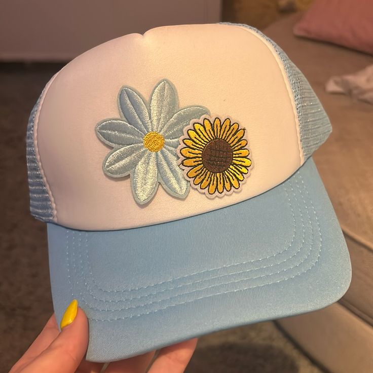 Light Blue Patched Unisex Trucker Hat With Sunflower And Daisy Blue Summer Trucker Hat, Spring Summer Trucker Hat, Trendy Blue Trucker Hat For Vacation, Trendy Yellow Trucker Hat For Spring, Blue Trucker Hat For Spring Vacation, Trendy Yellow Hats For Spring, Yellow Adjustable Trucker Hat For Spring, Adjustable Yellow Trucker Hat For Spring, Blue Trucker Cap For Spring