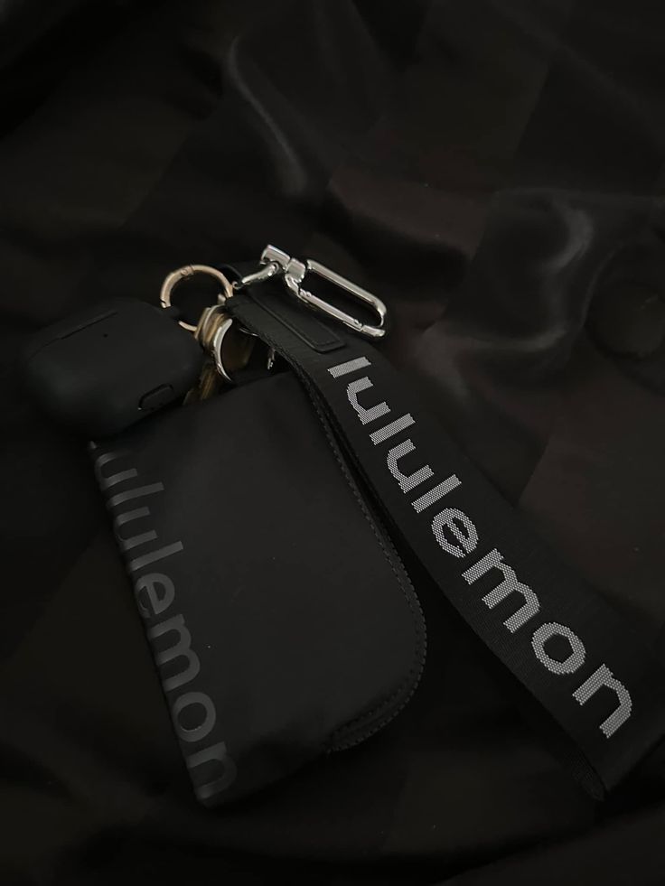 a black bag with a key chain attached to it