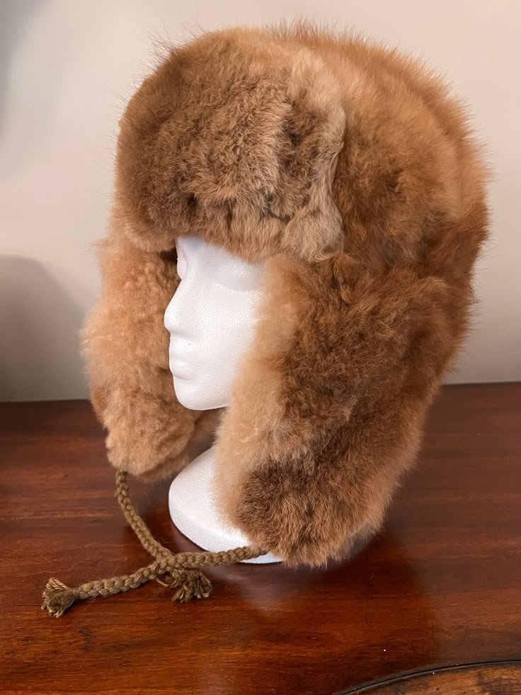 Experience ultimate luxury with our handmade Baby Alpaca Fur Trapper Hat. Crafted in the Andes region of Peru, this hat feels like a cozy cloud hugging your head. Perfect for outdoor activities like hiking, hunting, or living off-grid, it’s loved by hunters for its exceptional warmth—warmer than polar bear fur—while also regulating heat. Stay comfortable without overheating, as it adjusts to keep you warm when needed and cool when it’s not. The hypoallergenic baby alpaca fur on this Alpaca Fur T Adjustable Alpaca Hat For Outdoor, Warm Brown Hats For Outdoor Activities, Warm Brown Hat For Outdoor Activities, Alpaca Hat For Outdoor Winter Use, Sheepskin Hats With Ear Flaps For Outdoor, Sheepskin Outdoor Hat With Ear Flaps, Winter Outdoor Alpaca Hat, Brown Hats With Ear Flaps For Outdoors, Brown Hats With Ear Flaps For Outdoor Activities