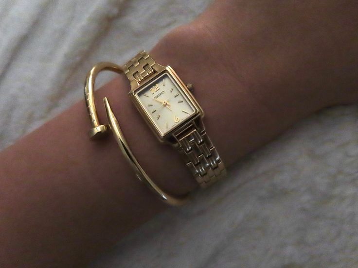 Dainty gold watch, rectangle watch, gold seiko watch, gold watch, gold jewelery, cartier nail bracelet, nail bracelet, gold nail bracelet, gold stack, gold watch and bracelet, watch aesthetic Cartier Rectangle Watch, Gold Dress Watch, Womens Rectangle Watches, Dainty Square Watch, Women’s Rectangle Watch, Delicate Gold Watch Women, Seiko Essentials Watch, Gold Square Watches Women, Cartier Bracelet Nail