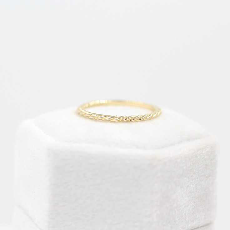 The Dainty Twist Stacking Ring is a graceful wedding band, making it a sleek standalone piece or a charming addition to any ring stack. Its intertwined design offers a modern twist on the classic wedding band, an ideal choice for those seeking an enchanting minimalist aesthetic. Details: 14k white, yellow, or rose gold, or platinum 1.5mm twisted band *This ring is not covered by our resizing policy--please double check your size. Modern Twist Stackable Rings For Promise, Modern Twist Stackable Twisted Promise Rings, Stackable Twisted Rings For Promise, Modern Twist Yellow Gold Stackable Rings With Open Band, Elegant Twisted Stackable Rings As Gift, Minimalist Twisted Jewelry For Anniversary, Elegant Stackable Round Band Midi Rings, Yellow Gold Stackable Rings With Modern Twist, Modern Twist Diamond Cut Ring For Anniversary