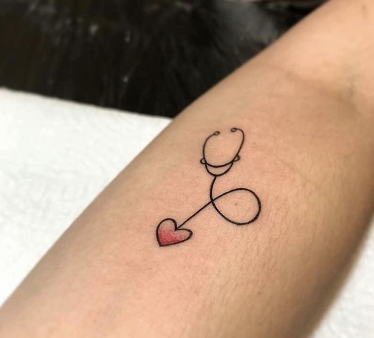 a tattoo with a stethoscope on the arm