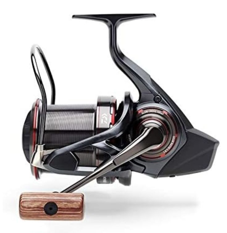 a spinning fishing reel next to a wooden stand