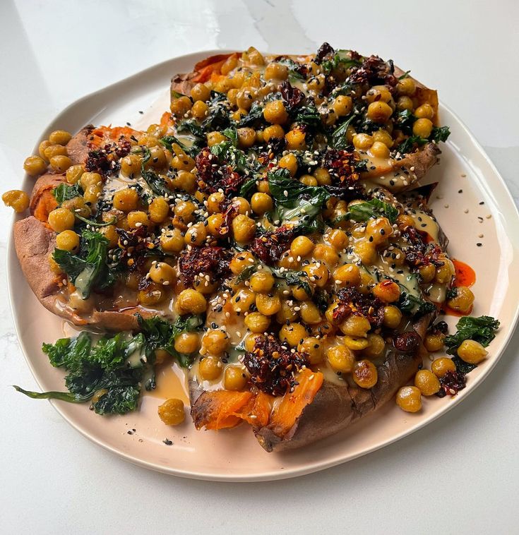 a white plate topped with meat covered in vegetables