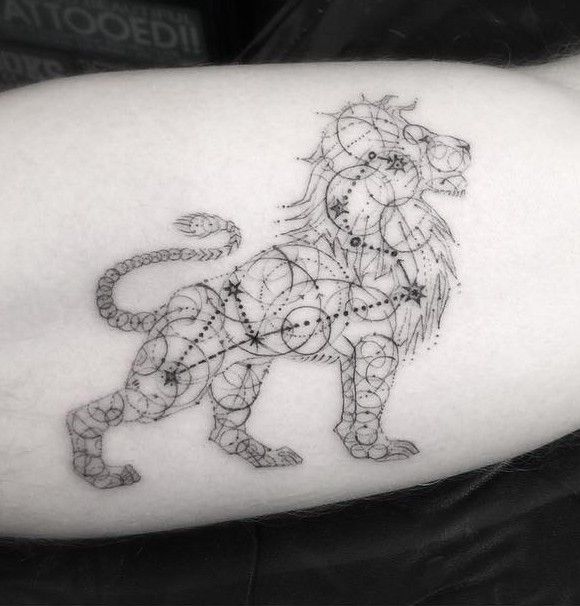 a lion tattoo on the right arm and shoulder, with many small details around it