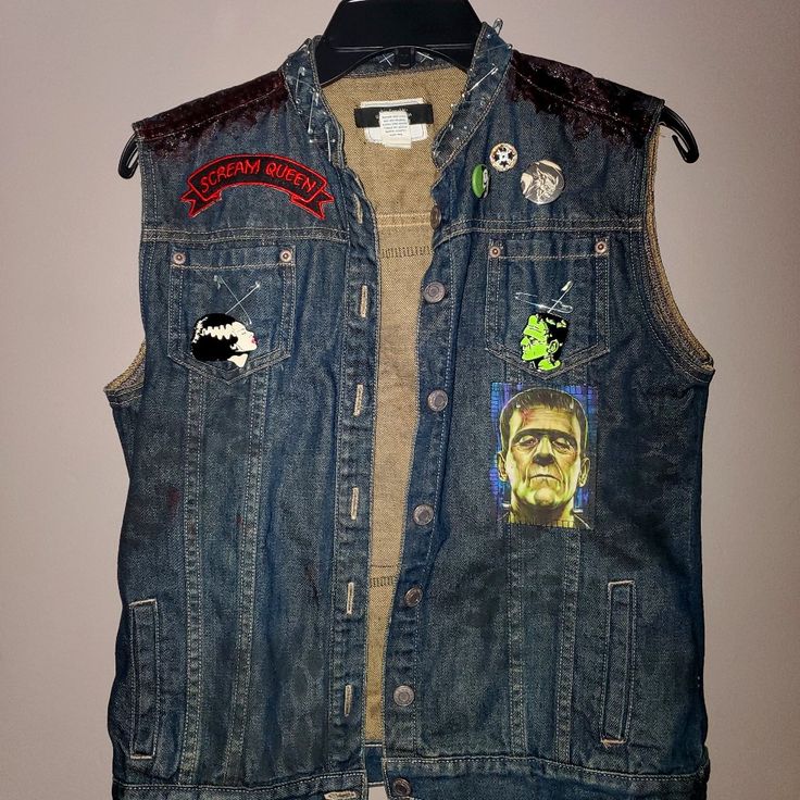 Handmade By Big Trouble Upcycled Fashion. Size Medium. The Bride Of Frankenstein And Frankie Are Both Present. Great Patches And Pins. Punk Denim Vest For Fall Streetwear, Punk Style Denim Vest For Fall Streetwear, Distressed Fitted Punk Outerwear, Fitted Punk Distressed Outerwear, Fitted Distressed Punk Outerwear, Alternative Cotton Outerwear For Concerts, Edgy Cotton Denim Jacket For Alternative Fashion, Alternative Style Cotton Outerwear For Concerts, Edgy Denim Vest For Fall Streetwear