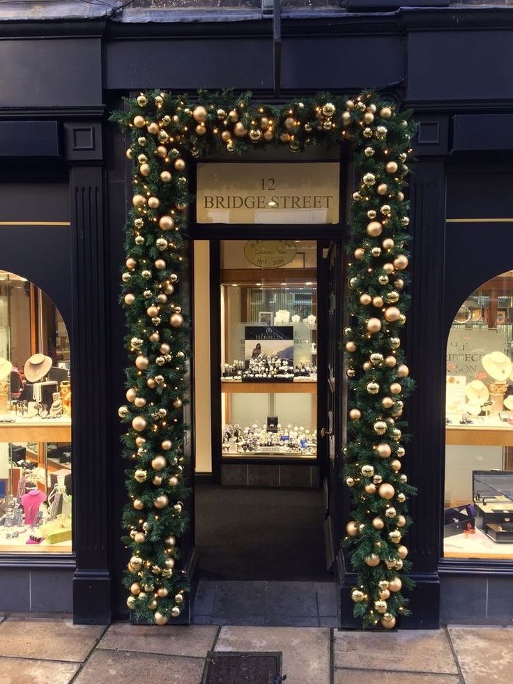 an entrance to a store decorated with christmas decorations